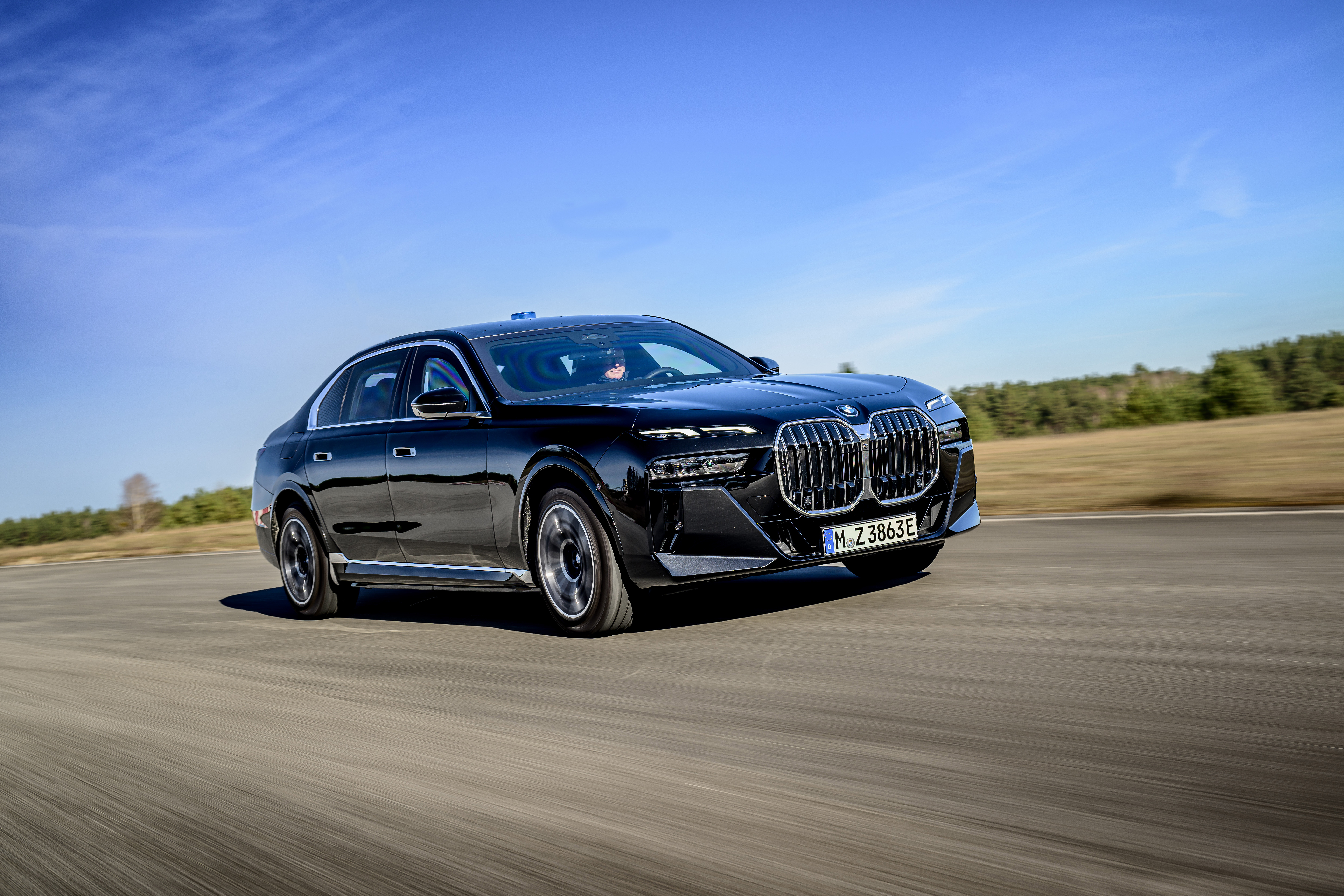 A BMW i7 driving.