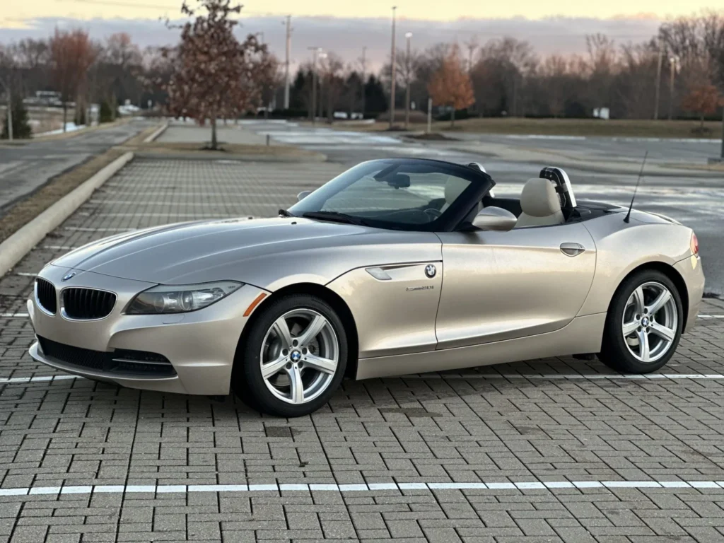 Silver E89 BMW Z4 parked with its top down.
