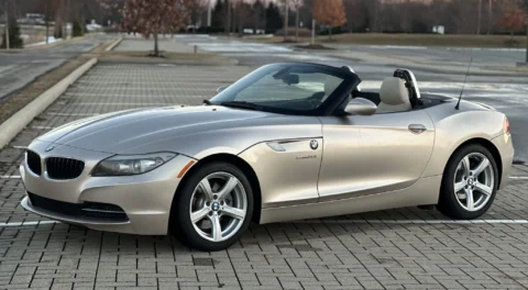 Silver E89 BMW Z4 parked with its top down.